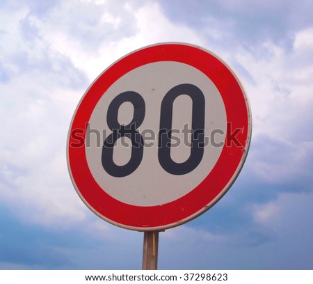 Speed sign against sky
