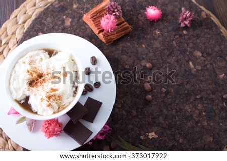 White Cup of coffee with a note about love. Old wooden table, dried flowers and leaves. Vintage style, a house in the village. Evening by the fireplace with a loved one.