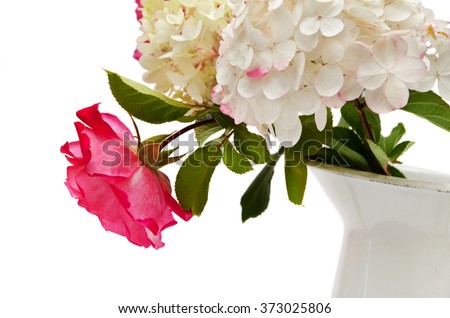 A hydrangea with a roses in the vase isolated on a white