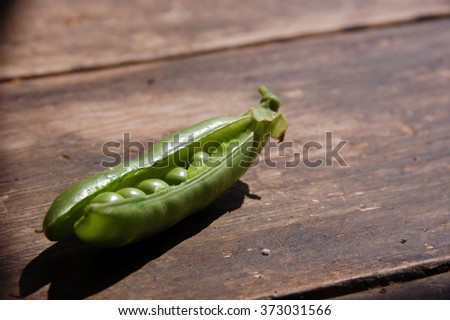 Close up of Fresh peas on wooden farm table