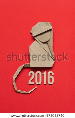 Folded paper origami moncey on red eco background. 2016 vertical postcard template.