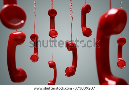 Red telephone receiver hanging over gray background concept for on the phone, on hold or contact us Royalty-Free Stock Photo #373039207