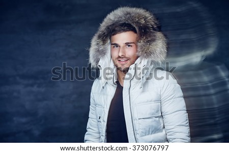 Smiling guy in white jacket with fur hood.