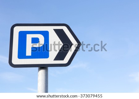 Car Parking directional sign against a partly cloudy sky background