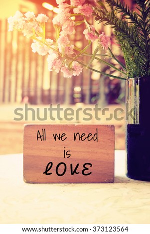 All we need is love Typography: Inspiration Motivational Life Quote on Wood Cube Decoration.