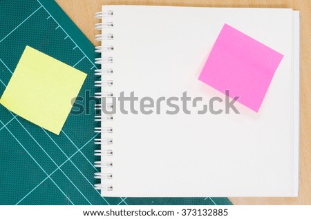 Notebook with cutting mat on wooden table, blank notebook, stationary, office, workspace