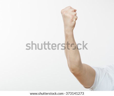 Man demonstrating his strong fist, white background