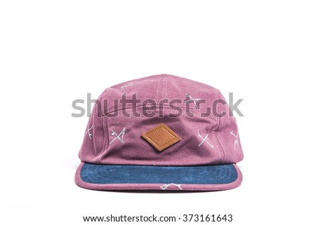 A pink fabric hat(cap) with pattern front side  on the bottom isolated white.