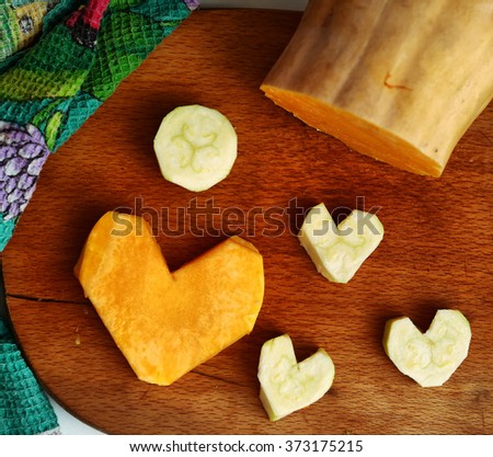 cut pumpkin and courgette in heart form image as food stylish decoration to valentines day dinner