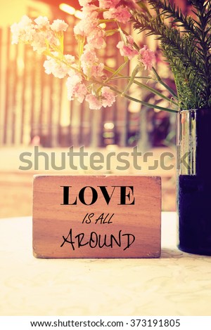Love is all around Typography: Inspiration Motivational Life Quote on Wood Cube Decoration.