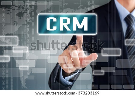 Businessman hands touching CRM  (or Customer Relationship Management) sign on virtual screen