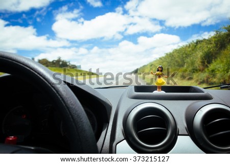 Hawaiian dancer doll in the car panel  Royalty-Free Stock Photo #373215127