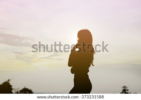 Silhouette woman walking alone in flower garden on winter