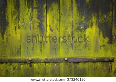 Old dark destroyed wooden wall background with green lichens and metal ferrule. Ideal background