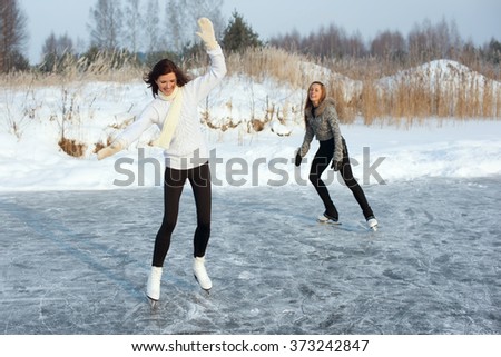 young Figure skating women at the frozen lake in the winter