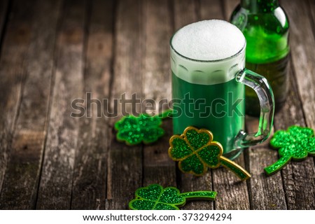 St. Patricks Day green shamrocks with a full cold frosty glass of beer Royalty-Free Stock Photo #373294294