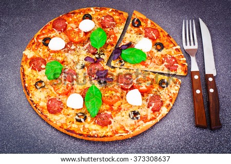 Pepperoni Pizza with Sausage, Cheese, Mozzarella, Olives and Basil Studio Photo