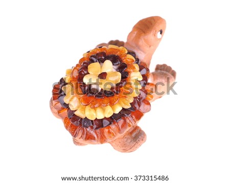 toy turtle with a shell made of amber on a white background