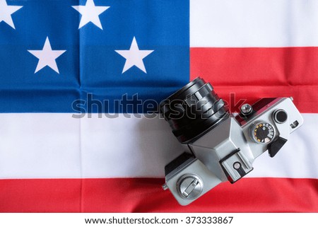 close-up American flag and retro photo camera background
