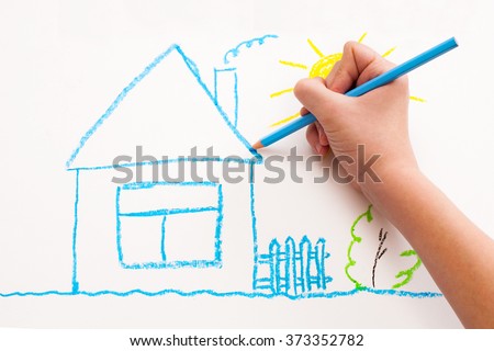 A child hand with pencil is drawing picture of country house