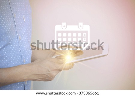 young man holding tablet computer with calendar , social media concept , color filter image , business concept , business idea