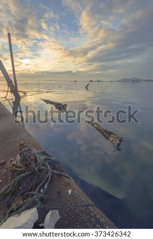Rope knots and Abandoned sinking boat at Fisherman's Jetty during sunrise 