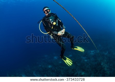 SCUBA diver next to a descend line on a deep dive site