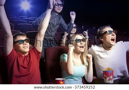 Young people sitting at the cinema, watching a film. Cinema photo series
