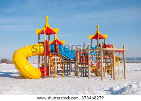 Children's playground with slides and ladders on the city's waterfront winter
