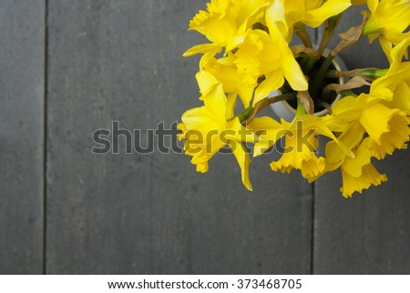 bouquet of daffodils on dark wooden table