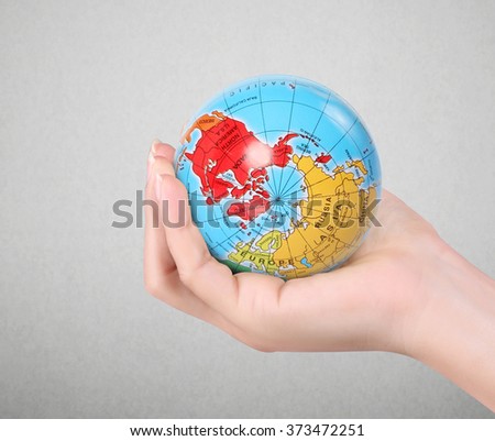 Human hand holding  globe  Elements of this image furnished by NASA