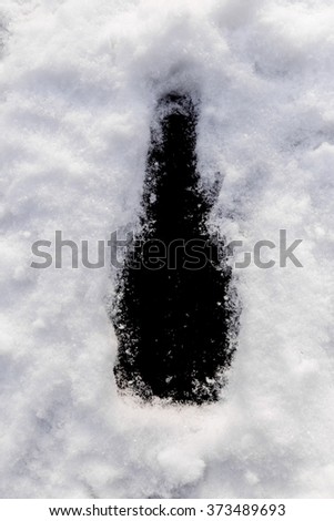 Black background bottle shape in the snow. Perfect window frame for any picture, just replace black color with your image in photo editor, by layered over it in screen mode.
