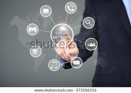 business, technology, internet and networking concept - businessman pressing button with Social Network on virtual screens. 
