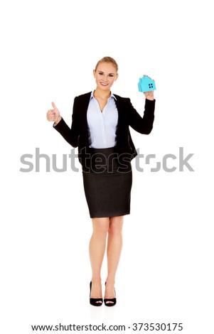 Smile business woman holding a paper house and show thumb up