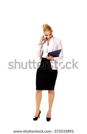 Thoughtful focused businesswoman reading her notes