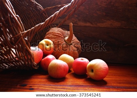 Basket of apples and pumpkin , Studio lighting , selective focus .
