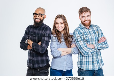 Multiethnic group of three confident smiling students standing 