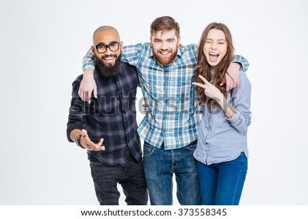 Group of happy three friends in casual wear standing and laughing  Royalty-Free Stock Photo #373558345