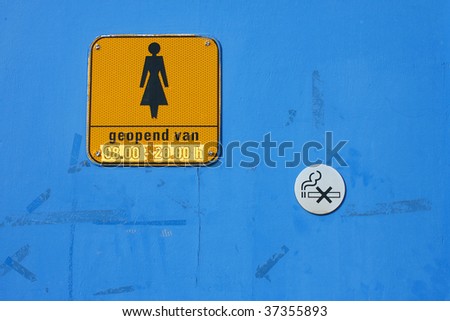 door with WC sign for women and no smoking button