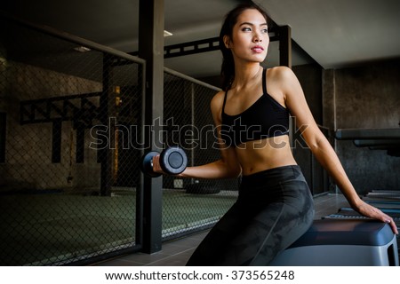 Asian women lift dumbbell 