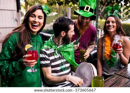 Friends celebrating St Patricks day with drinks in a bar Royalty-Free Stock Photo #373605667