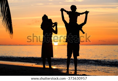 happy family with two kids having fun on sunset beach