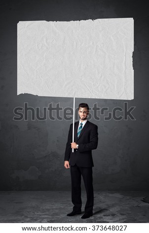 Young businessman holding a big blank booklet paper 