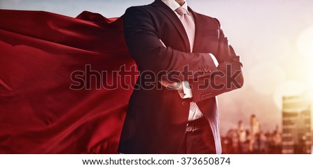 superhero businessman looking at city skyline at sunset. the concept of success, leadership and victory in business. Royalty-Free Stock Photo #373650874