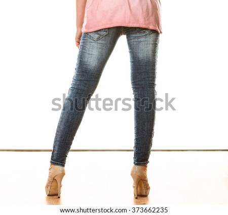 Fashion and people concept. Woman legs in denim trousers platform high heels shoes casual style isolated on white background