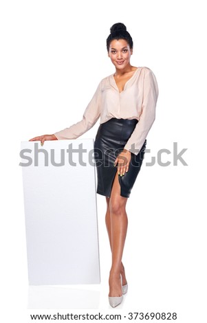 Confident business woman standing leaning at blank white banner in full length, over white background