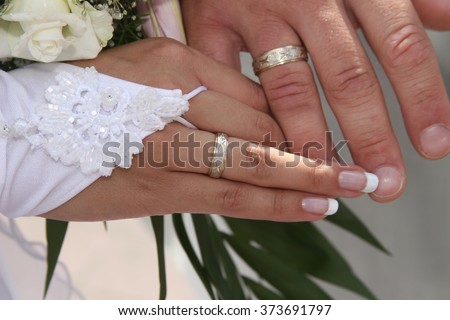 United hands of the bride and groom close up
