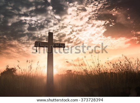 Resurrection of Easter Sunday concept: Silhouette cross on meadow sunrise background