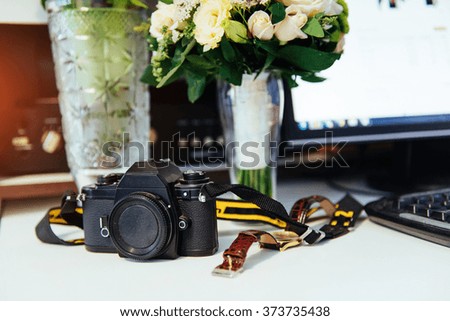 Photo retro camera on a table with different objects