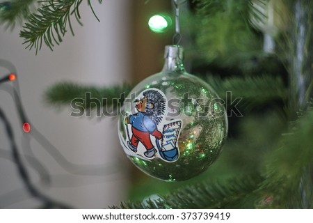 Old glass ball with picture on christmas tree close up, hedgehog postman, postbag, letters